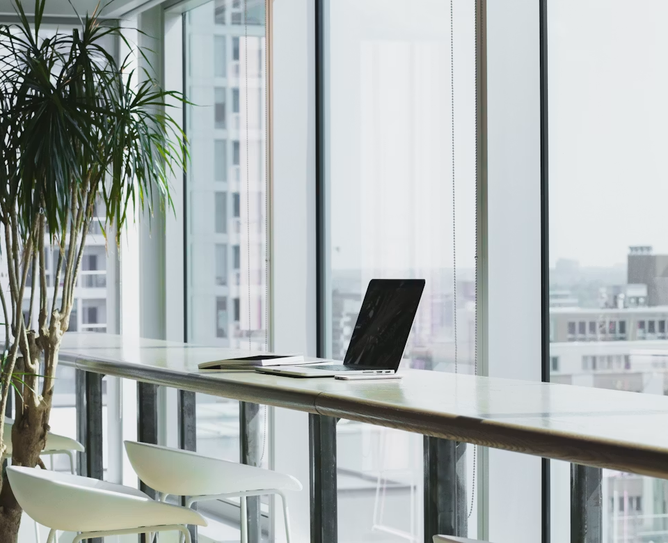 A quiet workspace overlooking a hazy city skyline
